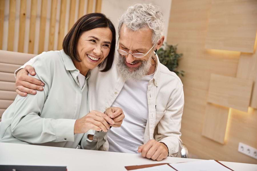 Happy unmarried couple signing their estate plan documents