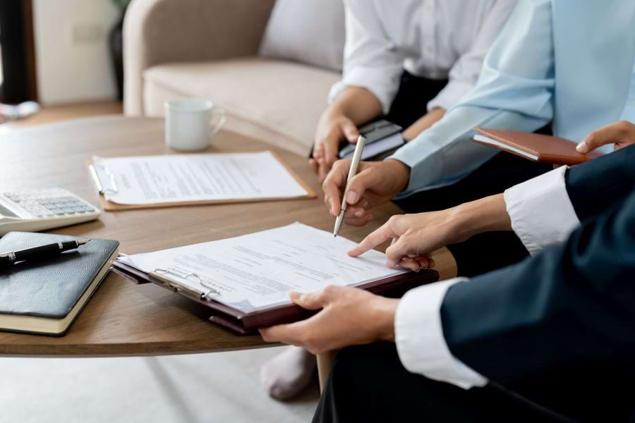Domestic partners discussing joint property plan with a lawyer