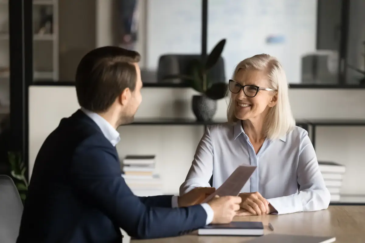 Attorney explaining a Durable Power of Attorney document to a family, allowing a trusted individual to manage financial and legal matters for a loved one experiencing cognitive decline or loss of capacity.